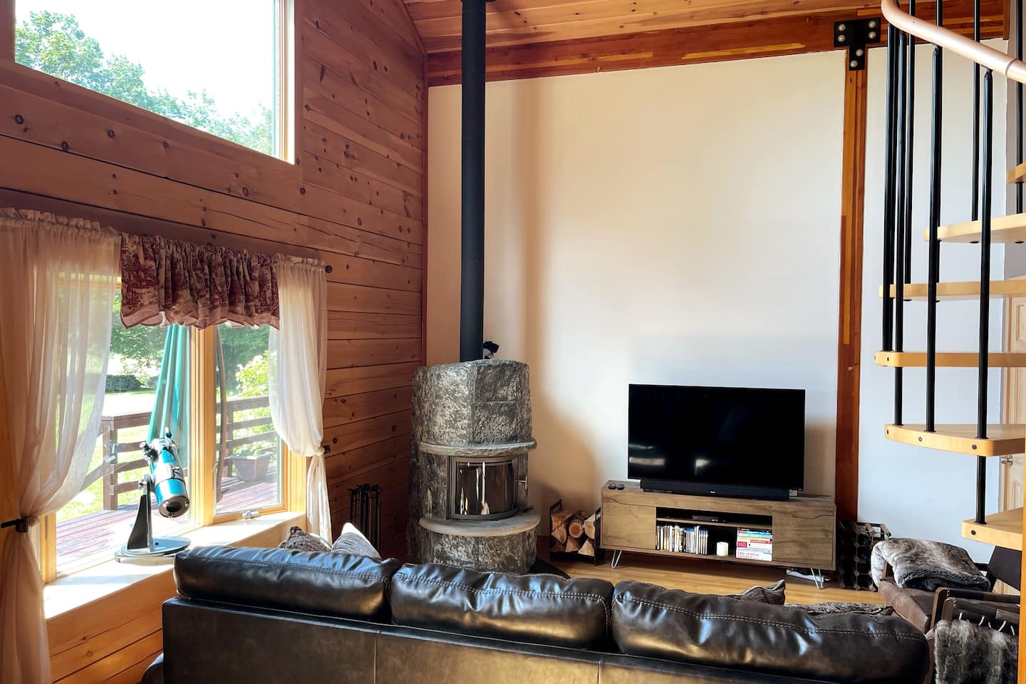 Living room with Soap Stone Wood Stove and Smart TV.